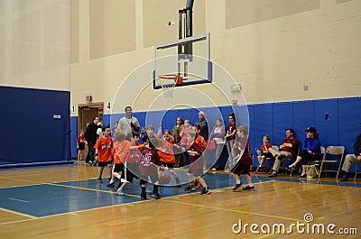 Kids playing basketball match