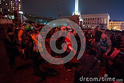 KIEV, UKRAINE - February 20, 2014: Euromaidan protesters breaking paving slabs