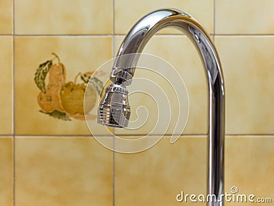 Kitchen Faucet Against a Tiled Wall