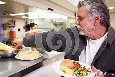 Kitchen Serving Food In Homeless Shelter