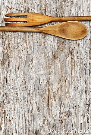 Kitchen utensils on the old wood background