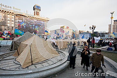 KYIV, UKRAINE: People walk past the army tents of the anti-government demonstrators during the pro-European protest