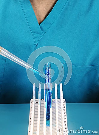 Lab Technician with Test Tubes and Pipette
