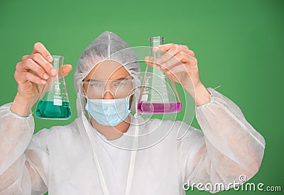 Laboratory technician holding up chemicals