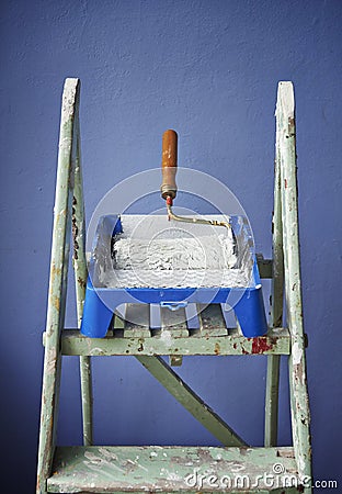 Ladder, paint can and paint roller