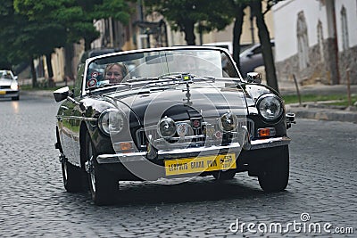 Lady driving vintage MG car at retrocar racing