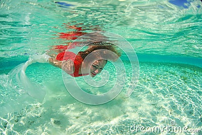 Lady in red swim dress water sea diving