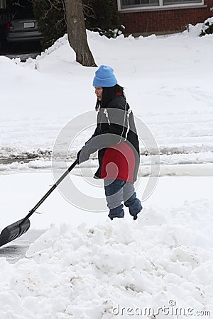 Lady Shoveling Snow from Driveway