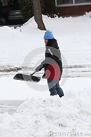 Lady Shoveling Snow from Driveway