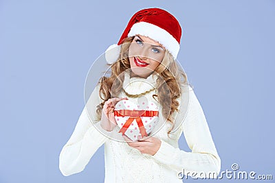 Lady wearing santa hat presenting gift