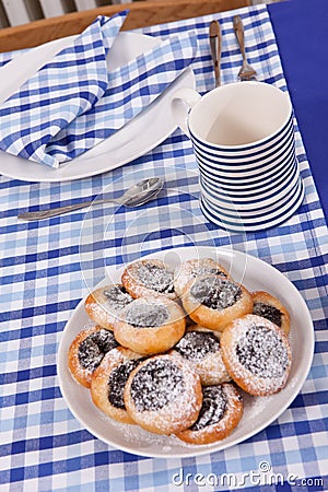 Laid table - fork and spoon laid on blue cloth and white plate