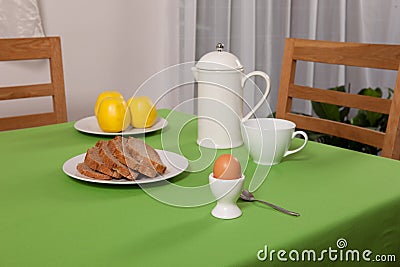 Laid table - fork and spoon laid on green cloth and white plate
