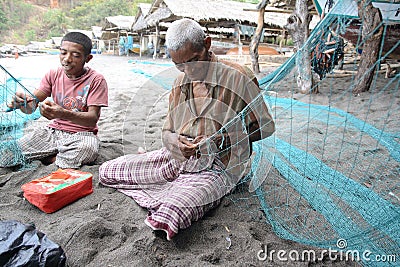 Lamalera whaler repairing fishing nets