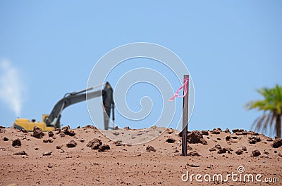 Land development flag post with bulldozer