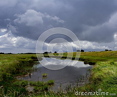 Landscape of lake and stormy sky