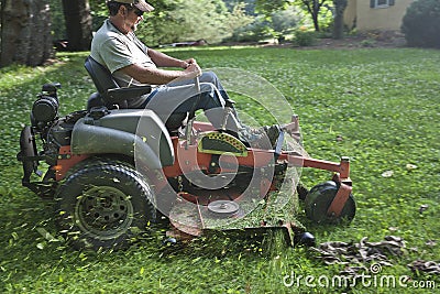 Landscaper on riding lawn mower