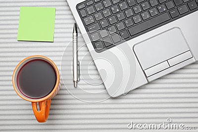 Laptop computer on desk with cup of tea