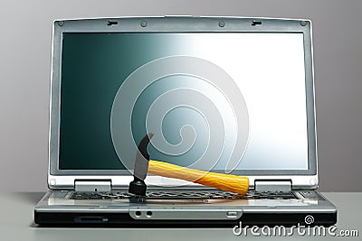 Laptop with a hammer on the screen