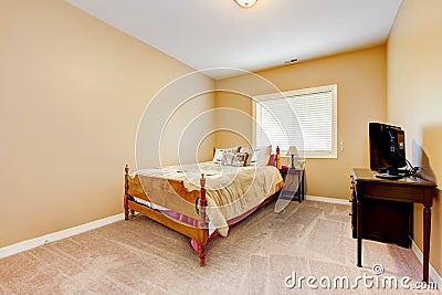 Large bedroom with yellow walls and beige carpet.