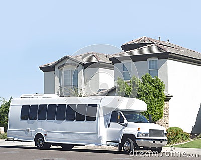 Large bus picking up from house