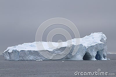 Large iceberg with several caves