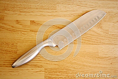 Stock Images: Large knife on a butcher block table