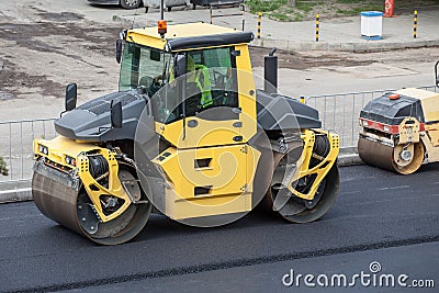 Large road-roller paving a road.