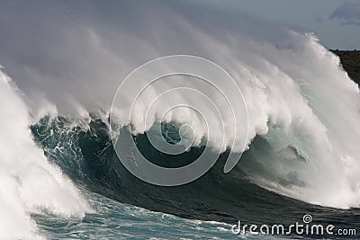 Large surf wave with barrel and wind.