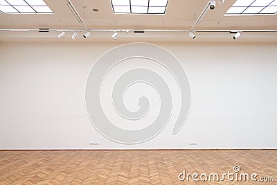 Large white wall with wooden floor tiles