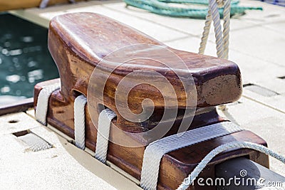 large wooden cleat onboard the deck of a sailing vessel.