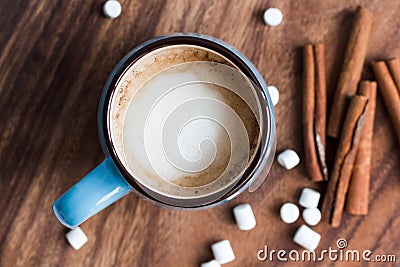 Latte with whipped cream on wood background