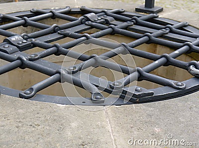 Latticed water well iron cover