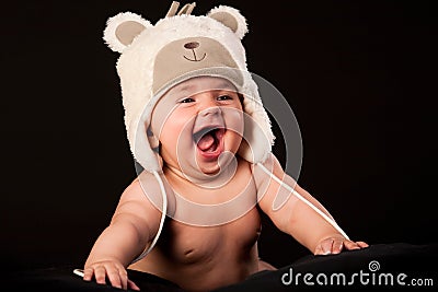 Laughing baby in bear cap