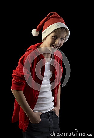 Laughing boy in Santa hat isolated on black background