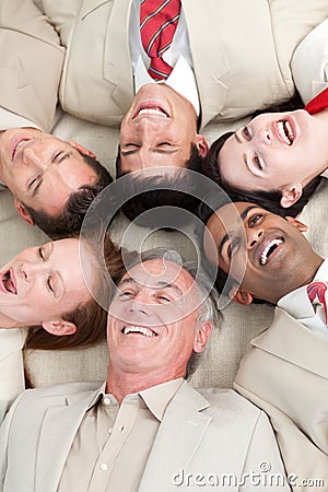 Laughing Business team lying in a circle