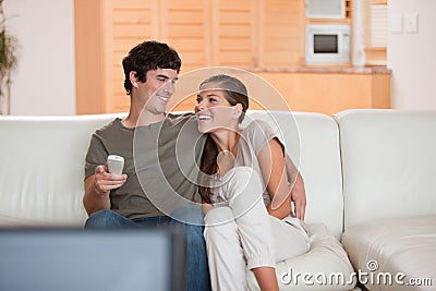 Laughing couple watching funny movie together