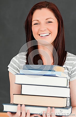Laughing young woman bringing books
