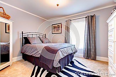 Lavender bedroom with white clothes cupboards