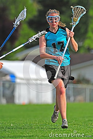 LAX player protecting the ball