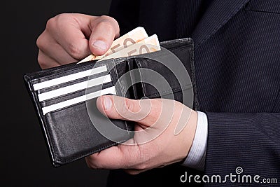 Leather purse with euro banknotes in business man hands