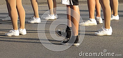 Legs and running shoes of several people