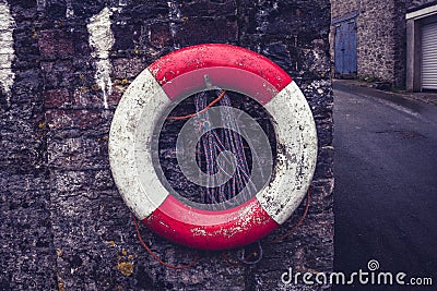 Life buoy on old stone wall