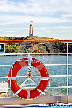 Life buoy on ship rail, view to Christ the King statue