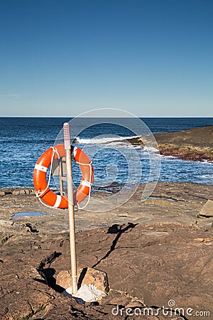 Life preserver buoy at sea rocks