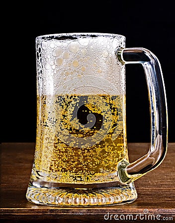 Light Beer in a glass pint mug served on a wooden