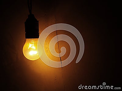 Light bulb on a dark wall