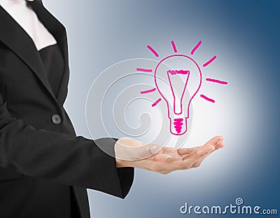 Light bulb in hand business woman on blue background.