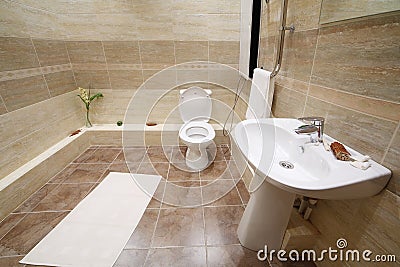 Light and clean toilet with tiles on floor
