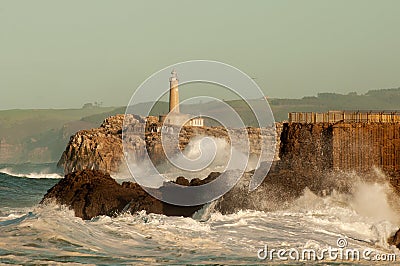 Lighthouse in the big waves, storm in Mouro, Santander