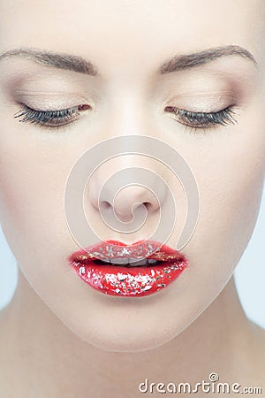 Lips of young blonde woman with vogue shining